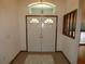 Inviting entryway featuring double doors, tile flooring, and an elegant chandelier at 20364 Sw 86Th Loop, Dunnellon, FL 34431