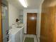 Laundry room with washer, dryer, sink, and door to outside at 20364 Sw 86Th Loop, Dunnellon, FL 34431