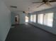 A bright sunroom has many windows, ceiling fans, and neutral carpeting at 20364 Sw 86Th Loop, Dunnellon, FL 34431