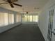 A sunroom with many windows and neutral carpet offers lots of light at 20364 Sw 86Th Loop, Dunnellon, FL 34431