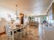 Open-concept dining room with stylish chandelier and views of adjacent living spaces at 23800 Ne 190Th St, Fort Mc Coy, FL 32134