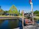 Scenic view of a wooden dock with a swing, overlooking the waterfront and charming lakeside house at 23800 Ne 190Th St, Fort Mc Coy, FL 32134