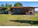 Rustic home with parking and a decorative facade at 23800 Ne 190Th St, Fort Mc Coy, FL 32134
