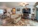 Inviting open-concept living space featuring tile flooring, dining area, and entertainment center at 23800 Ne 190Th St, Fort Mc Coy, FL 32134
