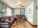 Cozy living room with vintage decor, featuring wood trim, ceiling fan and comfortable seating at 23800 Ne 190Th St, Fort Mc Coy, FL 32134