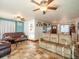 Spacious living room with tile floors, ceiling fans and plentiful seating at 23800 Ne 190Th St, Fort Mc Coy, FL 32134