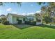 Large backyard with well-maintained green grass and a pleasant home exterior at 28 Gordon Ct, Leesburg, FL 34788