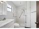 Clean bathroom with shower, white tile, and accessibility handrails at 28 Gordon Ct, Leesburg, FL 34788