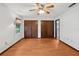 Spacious bedroom featuring wood floors, ceiling fan, and natural light at 28 Gordon Ct, Leesburg, FL 34788