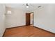Clean bedroom with wood-look floors, a ceiling fan and neutral walls at 28 Gordon Ct, Leesburg, FL 34788