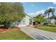 Well-maintained home featuring a spacious driveway, lush lawn, and charming curb appeal with mature trees at 28 Gordon Ct, Leesburg, FL 34788