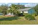 Lovely single-story home with well-kept landscaping, mature palm trees, and a cozy, screened-in porch at 28 Gordon Ct, Leesburg, FL 34788