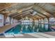 Indoor pool area with wooden vaulted ceiling and well lit with natural light at 28 Gordon Ct, Leesburg, FL 34788