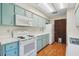Charming kitchen showcases blue cabinets, white appliances, and lots of counter space creating an efficient cooking environment at 28 Gordon Ct, Leesburg, FL 34788