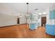 Open-concept kitchen and living room with bright blue cabinetry and appliances providing a functional cooking and living space at 28 Gordon Ct, Leesburg, FL 34788