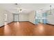Open-concept living space showcasing beautiful flooring, a bright kitchen, and a welcoming atmosphere for entertaining at 28 Gordon Ct, Leesburg, FL 34788