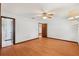 Main bedroom with wood floors, ceiling fan, and access to bathroom creating a comfortable and private living space at 28 Gordon Ct, Leesburg, FL 34788