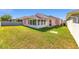 View of the home's backyard and screened-in lanai area, offering a relaxing outdoor space at 2935 Sw 41St Pl, Ocala, FL 34474