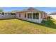 A view of the home's screened-in porch and spacious backyard, perfect for outdoor activities at 2935 Sw 41St Pl, Ocala, FL 34474