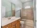 The bathroom features a tub and shower combo, a sink, and a decorative mirror at 2935 Sw 41St Pl, Ocala, FL 34474