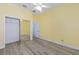 This bedroom has a mirror closet, fan and flooring at 2935 Sw 41St Pl, Ocala, FL 34474