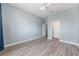 This bright bedroom features modern floors, light blue walls, and a ceiling fan for ultimate comfort at 2935 Sw 41St Pl, Ocala, FL 34474