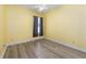 This bright bedroom features modern floors, yellow walls, and a window for natural light at 2935 Sw 41St Pl, Ocala, FL 34474