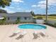 Inviting community pool with lounge chairs for relaxation and well-kept landscape at 2935 Sw 41St Pl, Ocala, FL 34474