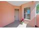 Inviting front porch with a charming pink facade, a flower pot, and a well-maintained entrance at 2935 Sw 41St Pl, Ocala, FL 34474