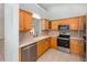 Modern kitchen with stainless steel appliances and light wood cabinets at 2935 Sw 41St Pl, Ocala, FL 34474
