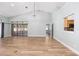 Open living space featuring vaulted ceiling, sliding glass doors, and wood flooring at 2935 Sw 41St Pl, Ocala, FL 34474