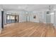 Open-concept living room with wood floors, vaulted ceilings, and modern lighting fixtures at 2935 Sw 41St Pl, Ocala, FL 34474