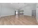 Open living room with vaulted ceilings, modern flooring, natural light, and access to the screened-in patio at 2935 Sw 41St Pl, Ocala, FL 34474