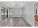 This primary bedroom features wood floors, a fan, large sliding doors, and two windows at 2935 Sw 41St Pl, Ocala, FL 34474