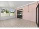 The bright sunroom has large windows, tile floors, and doors to outside at 2935 Sw 41St Pl, Ocala, FL 34474