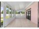 The bright sunroom has large windows, and tile flooring at 2935 Sw 41St Pl, Ocala, FL 34474