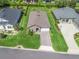 Aerial shot of a well-maintained home featuring lush green lawn and a patterned driveway leading to an attached garage at 3840 Se 6Th Ave, Ocala, FL 34480