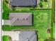 An aerial view showing a landscaped lawn surrounding a home with a gray roof and well-maintained green spaces at 3840 Se 6Th Ave, Ocala, FL 34480