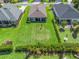 Aerial view of a well-maintained backyard with lush green grass and manicured landscaping, offering privacy and space at 3840 Se 6Th Ave, Ocala, FL 34480