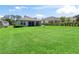 Lush backyard with a large lawn and privacy hedges bordering other homes at 3840 Se 6Th Ave, Ocala, FL 34480