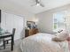 Cozy bedroom with a ceiling fan, dresser with mirror, and comfortable bed at 3840 Se 6Th Ave, Ocala, FL 34480