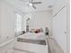 Bright bedroom with a ceiling fan, closet, and a white bed with soft bedding at 3840 Se 6Th Ave, Ocala, FL 34480