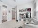 Cozy bedroom featuring neutral walls, carpet, and an open closet showcasing built-in storage and a comfortable couch at 3840 Se 6Th Ave, Ocala, FL 34480