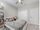 Cozy bedroom with a ceiling fan, closet, and a white bed with comfortable bedding at 3840 Se 6Th Ave, Ocala, FL 34480