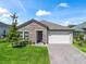 Charming exterior elevation featuring stone accents, an attached garage, and manicured landscaping creating curb appeal at 3840 Se 6Th Ave, Ocala, FL 34480