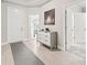 Welcoming foyer with tiled floors, a gray cabinet, and access to other rooms at 3840 Se 6Th Ave, Ocala, FL 34480