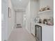 Well-lit hallway with a bar and wine cooler area, leading to other rooms at 3840 Se 6Th Ave, Ocala, FL 34480