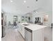 The kitchen features an island with a sink and stainless steel dishwasher overlooking the living space at 3840 Se 6Th Ave, Ocala, FL 34480