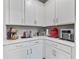 This kitchenette offers generous countertop space and sleek, white cabinetry at 3840 Se 6Th Ave, Ocala, FL 34480