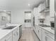 Bright kitchen features stainless steel appliances, gas cooktop, and modern white cabinets at 3840 Se 6Th Ave, Ocala, FL 34480